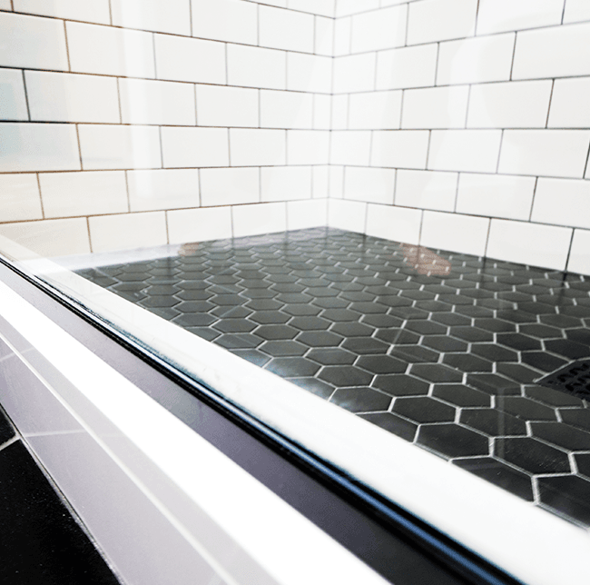 shower floor with black hexagonal tiles