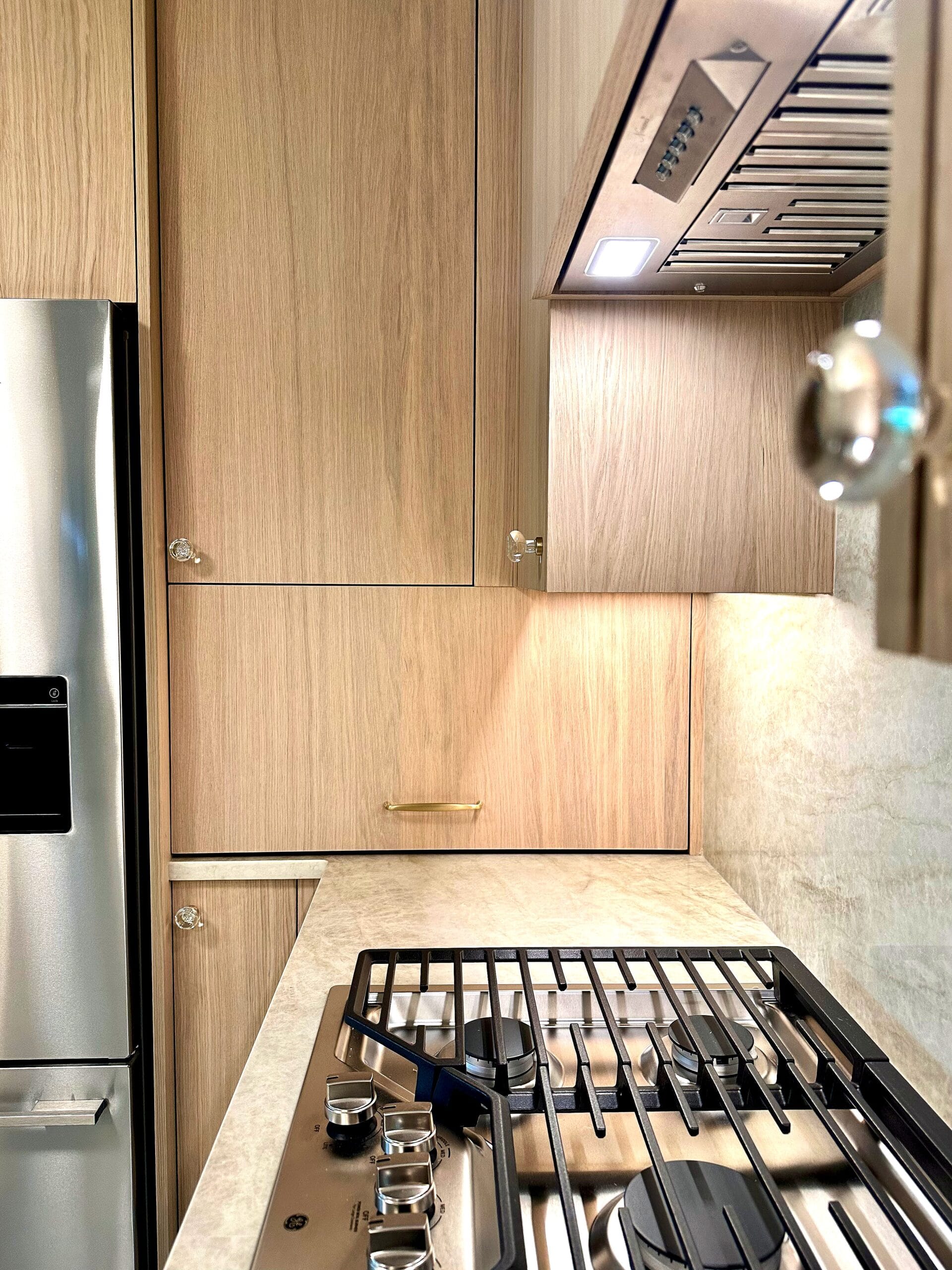 Modern Scandinavian Kitchen Remodel in Hudson Valley, NY featuring minimalist light wood cabinetry, stainless steel appliances, and a sleek built-in gas cooktop