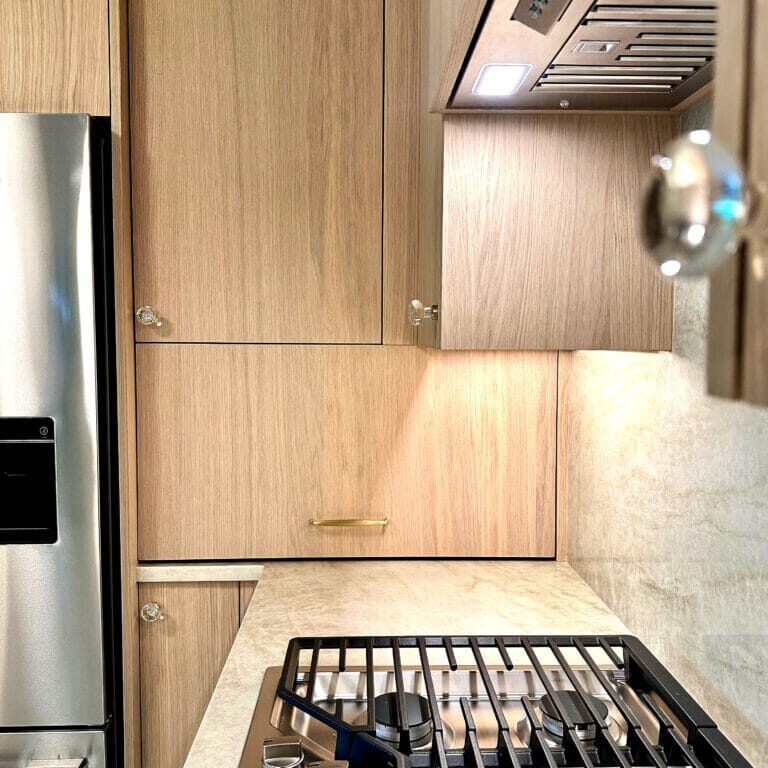 Modern Scandinavian Kitchen Remodel in Hudson Valley, NY featuring minimalist light wood cabinetry, stainless steel appliances, and a sleek built-in gas cooktop